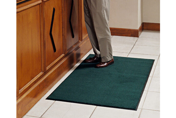 person standing on a floor mat