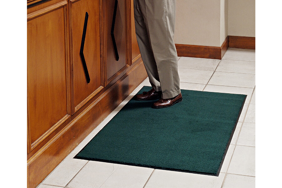 person standing on a floor mat