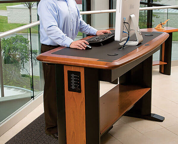 man at a standing desk with an anti-fatigue mat under his feet