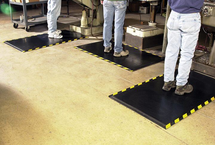 Workers standing on anti-fatigue mats