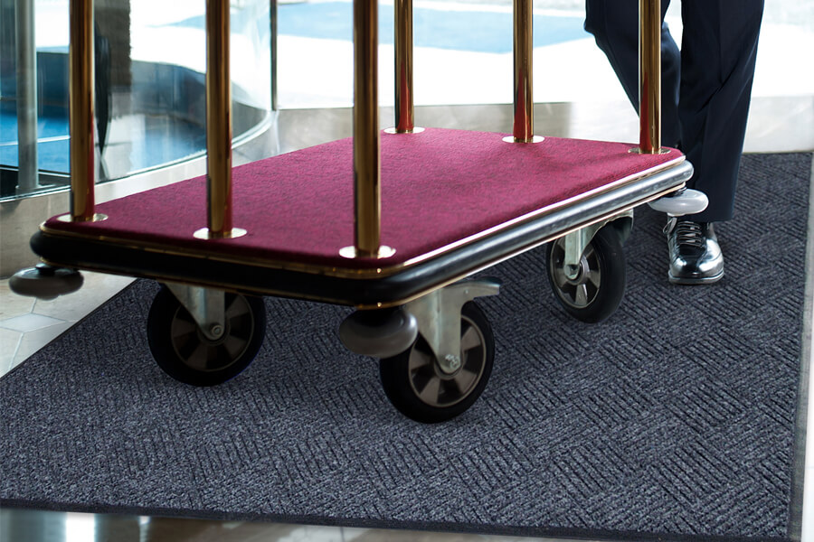 cart rolling over a waterhog mat