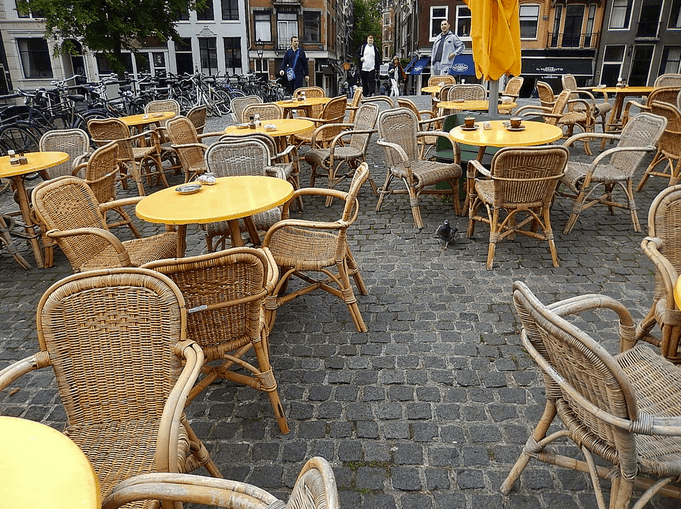 a group of outdoor dining tables and chairs