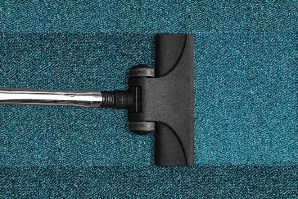 a carpet cleaner cleaning a mat
