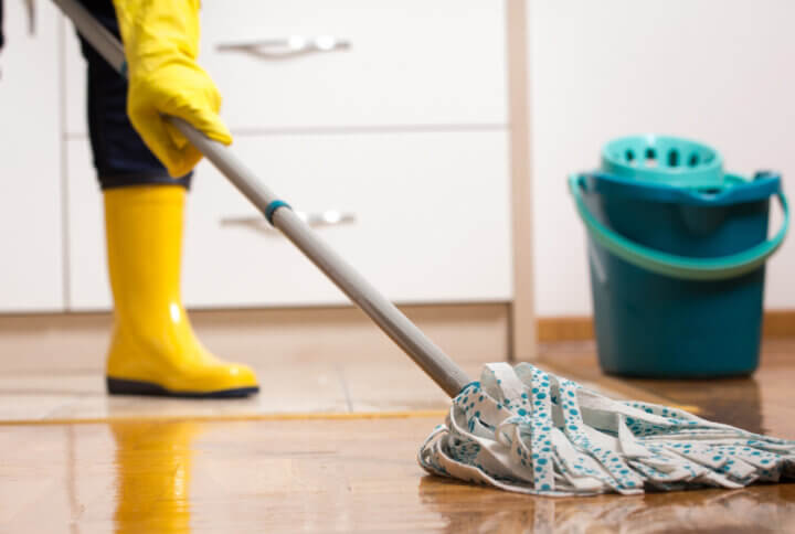 Housekeeper mopping tiled floor